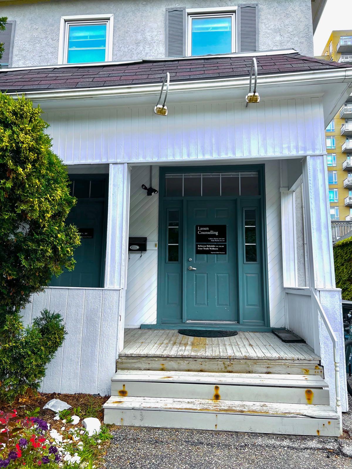 Shared office entrance at 16 John St W, Waterloo — teal front door on the porch